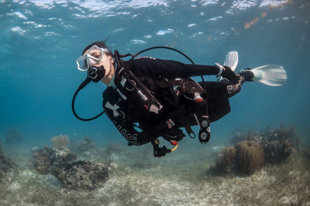 Scuba diver exploring coral reef in Cancun Caribbean waters